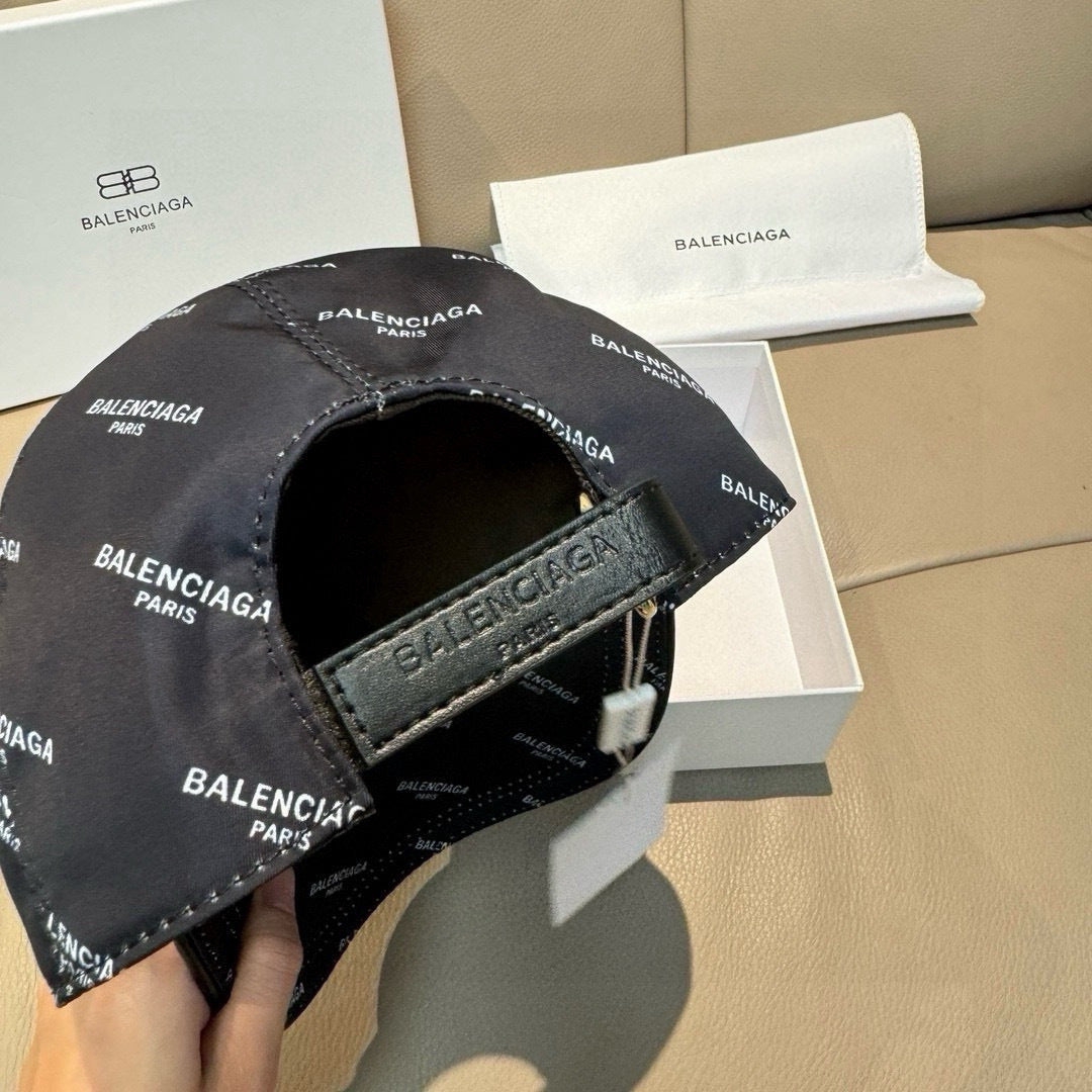 Burberry cap with dark adjustable strap and buckle; BALENCIAGA logo print