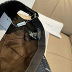 Burberry cap interior view with dark strap, metal buckle, and BALENCIAGA label