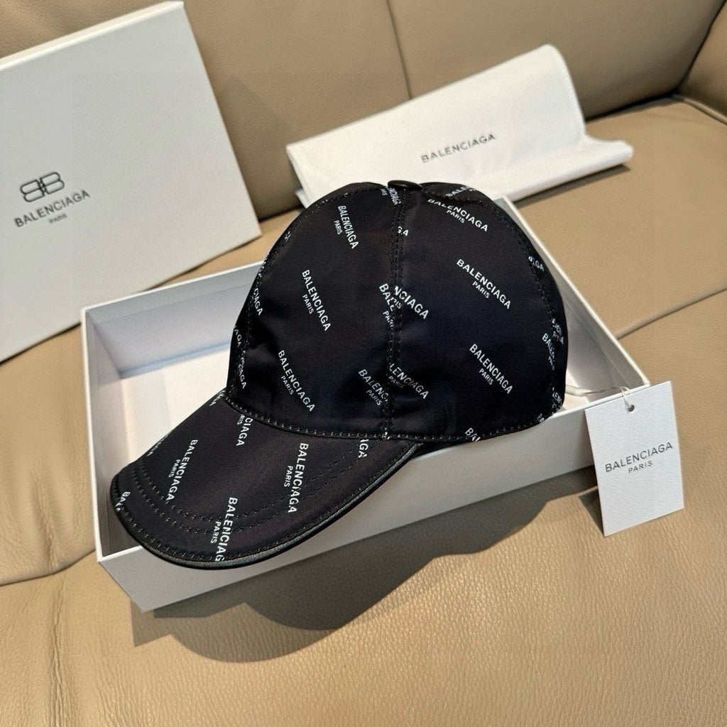 Balenciaga cap in black with repeating BALENCIAGA logo, front and brim shown.