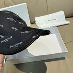 Balenciaga cap in black with curved brim; top view of logo fabric and stitching.