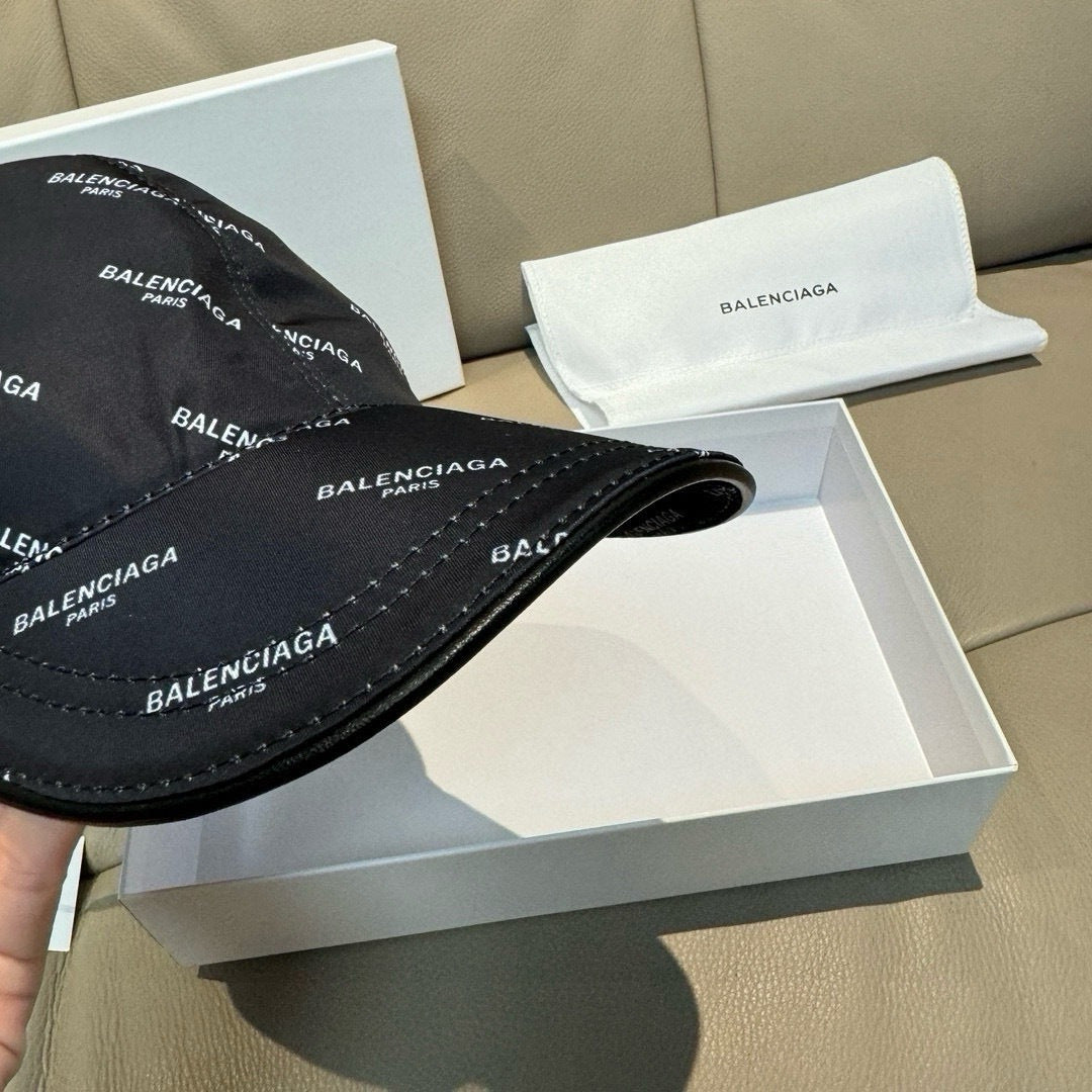 Balenciaga cap in black with curved brim; top view of logo fabric and stitching.