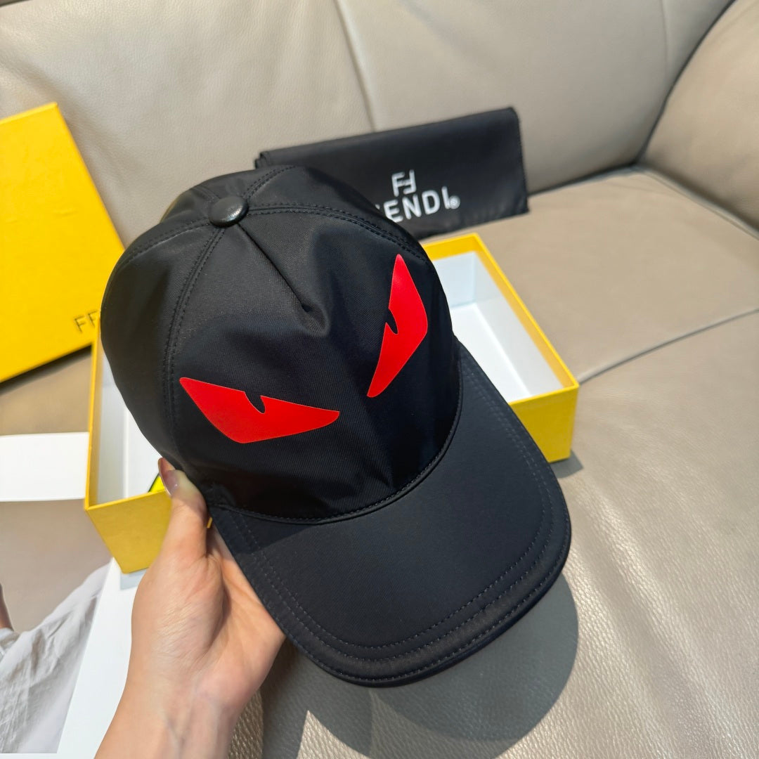Fendi cap in black with red logo graphic and round button on top.