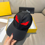 Fendi cap in black with red logo graphic and curved brim held in hand.