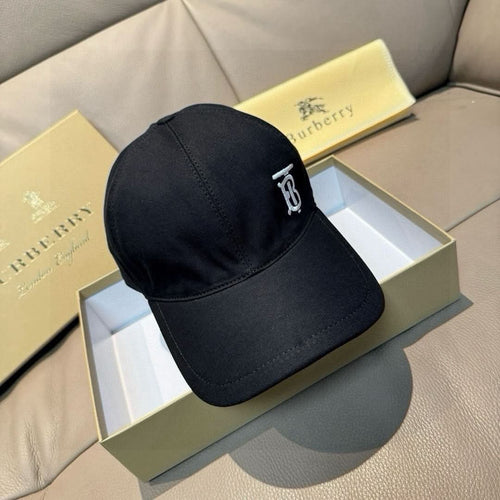Dark baseball cap with curved brim and small monogram logo at the back