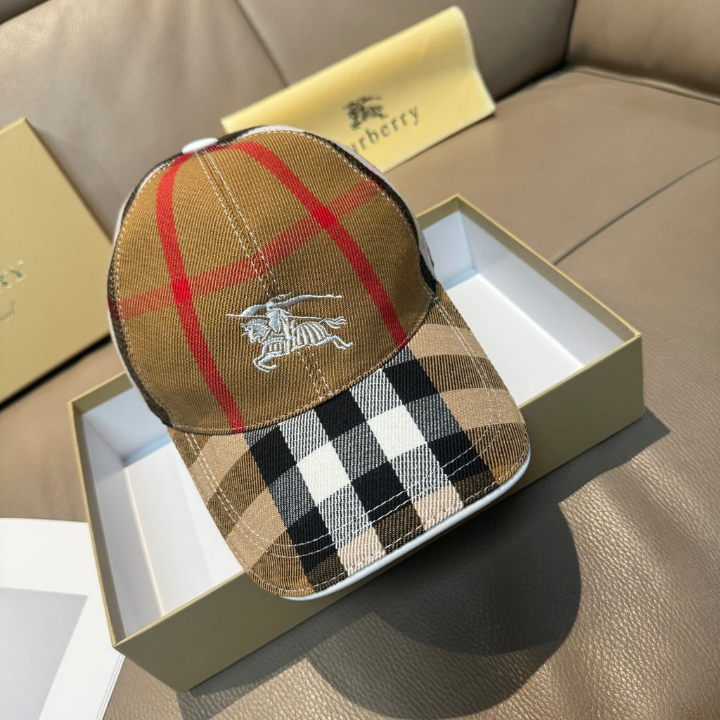 Burberry cap in tan, red, and black plaid with horse emblem on front.
