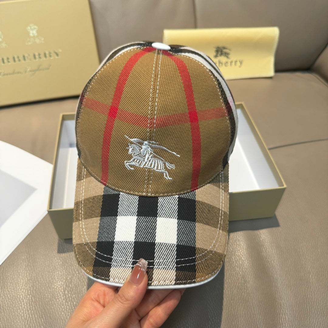 Burberry cap with front horse emblem on tan plaid crown.
