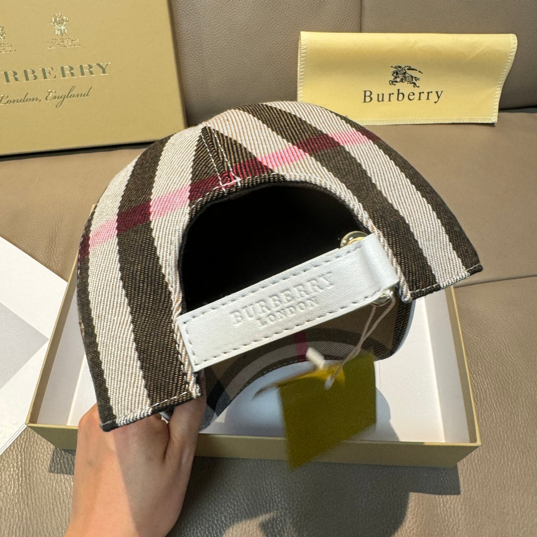 Burberry cap side view with plaid fabric and white strap label.