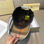 Burberry cap interior view with plaid brim and black inner lining.