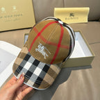 Burberry cap in tan plaid with horse emblem on the front panel.