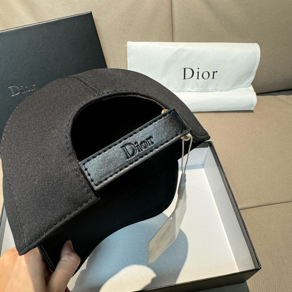 Black Dior baseball cap with adjustable fabric strap and Dior label on underside