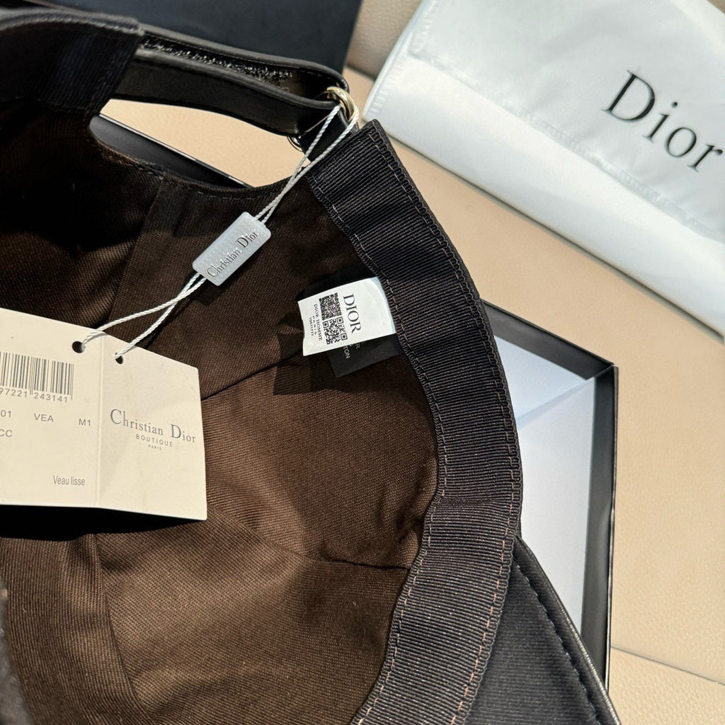 Black Dior cap strap detail with hanging tags and Dior patch, curved brim