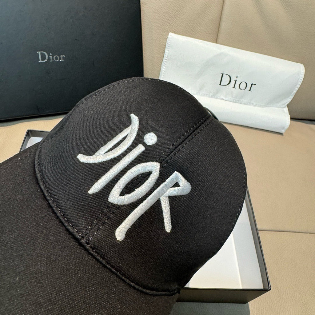 Black Dior baseball cap close-up with white embroidered Dior lettering on crown