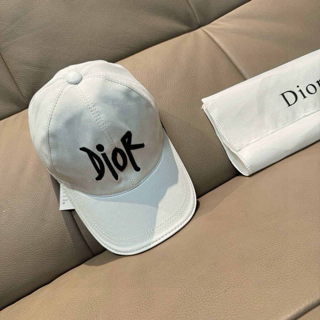 White Dior cap with black 'Dior' logo, side view, curved brim and stitched panels.
