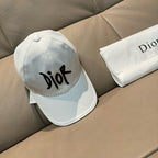 White Dior cap with black 'Dior' logo, side view, curved brim and stitched panels.