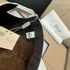 Black Dior cap with adjustable strap and hanging tags, gift box included.