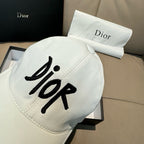 White Dior cap with large black 'Dior' logo on front, curved brim.