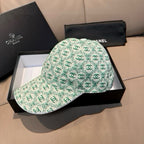Chanel cap in mint green CC logo pattern, curved brim and open crown, front view.