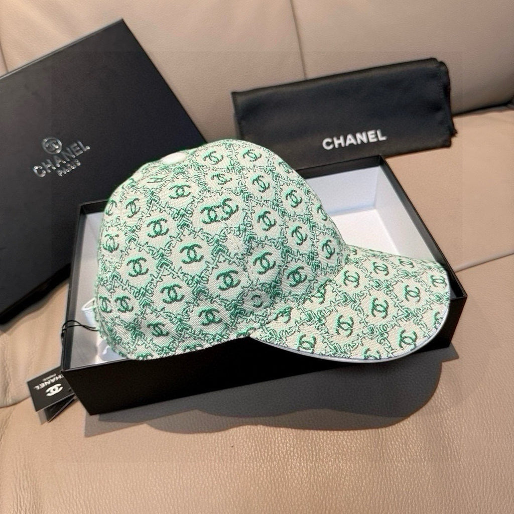 Chanel cap in mint green with repeating CC logos, curved brim and buttoned front.