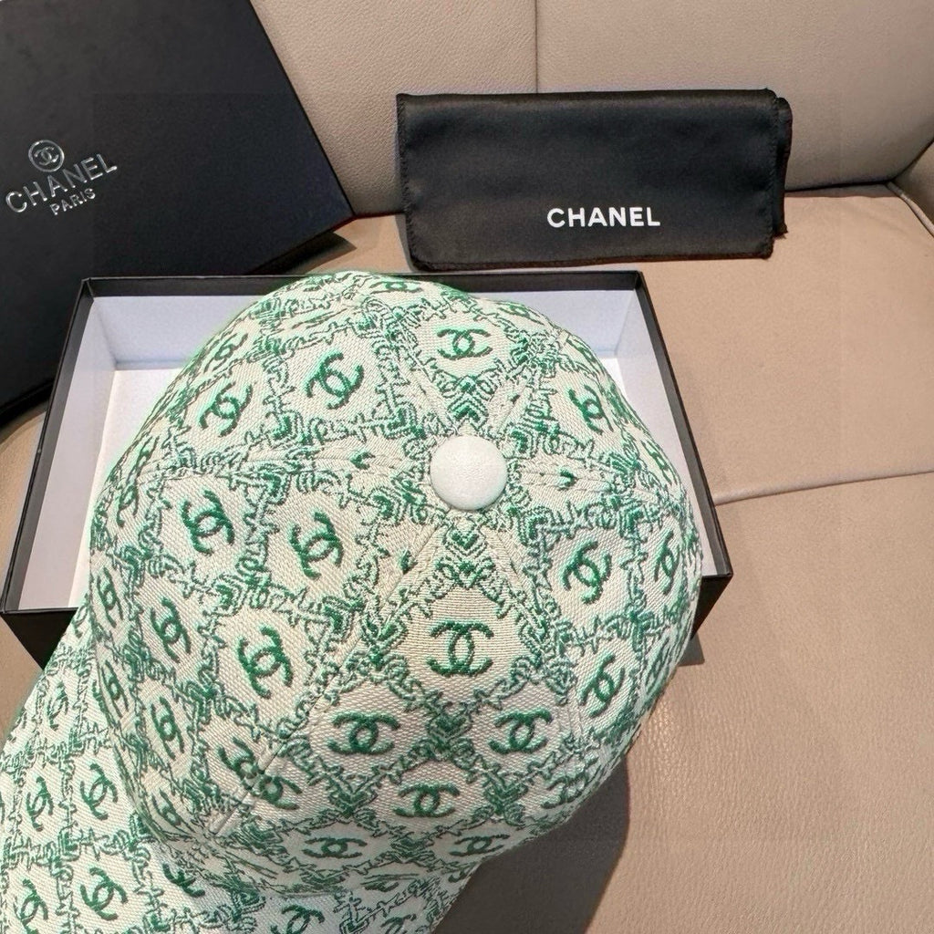Chanel cap, mint green CC logo pattern with round button center, side view.