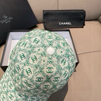 Chanel cap, mint green CC logo pattern with round button center, side view.