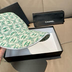 Chanel cap in mint green CC logo pattern, front panel and brim in view.