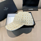 Chanel beige and gold monogram baseball cap with curved brim and stitched front panel.