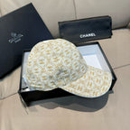 Curved-brim baseball cap in beige with gold monogram pattern and a low-profile crown.