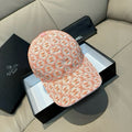 Orange logo baseball cap with pink button detail, curved brim and fabric pattern