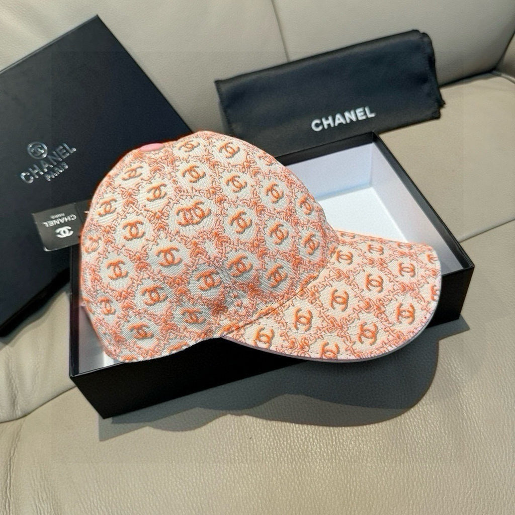 Peach-orange logo baseball cap with curved brim and pink button on top