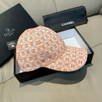 Peach-orange logo baseball cap with curved brim and pink button on top