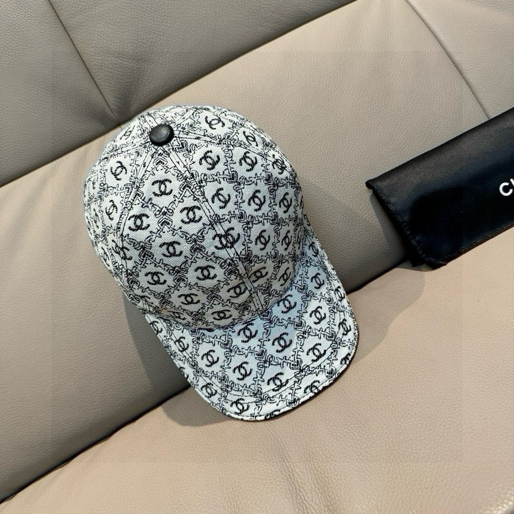 Chanel cap with white-and-black logo pattern, small round top button