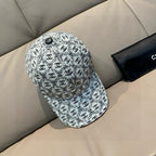 Chanel cap with white-and-black logo pattern, small round top button