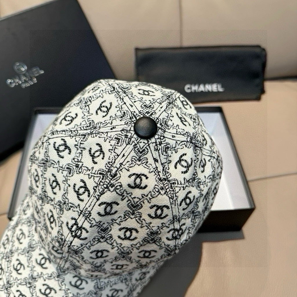 Chanel cap with white-and-black logo pattern and dark round top button