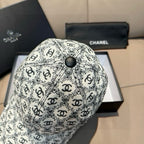 Chanel cap with white-and-black logo pattern and dark round top button