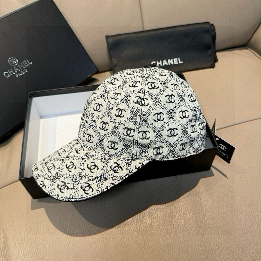 Chanel logo cap in white with black repeating pattern, curved brim