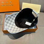 Louis Vuitton cap with checkered brim, black interior lining, and light trim