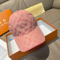 Louis Vuitton cap in pink with repeating monogram pattern and curved brim.