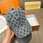 Louis Vuitton monogram cap in dark gray with round top button and repeating icons