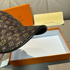 Dark monogram baseball cap underside view with strap, on display box