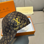 Dark monogram baseball cap with large gold Louis Vuitton emblem, back view