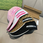 Assorted Gucci caps: pink, tan, and dark GG monogram designs with logo bands.
