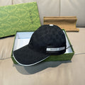 Gucci cap in dark fabric with GG monogram, GUCCI band, and white-trim brim edge.