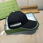Gucci baseball cap in dark GG monogram with GUCCI logo band and curved brim.