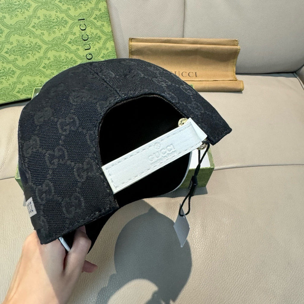 Gucci cap back view with dark GG monogram and white inner label near opening.