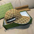 Beige GG-pattern baseball cap with wide black front patch reading GUCCI.