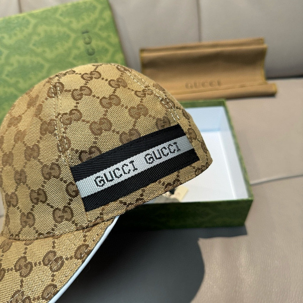 Beige GG-pattern baseball cap close-up with black GUCCI front patch.