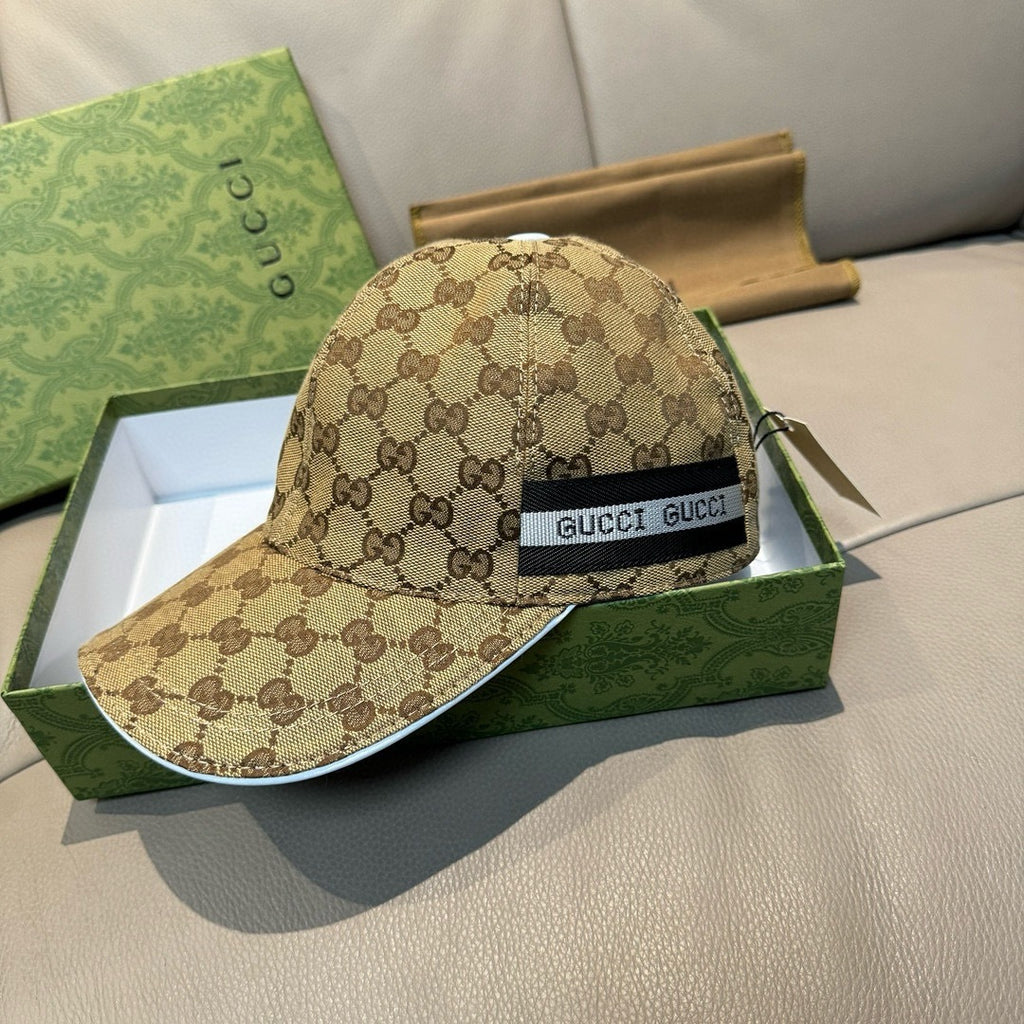 Beige GG-pattern baseball cap with black front patch reading GUCCI.