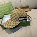 Beige GG-pattern baseball cap with black front patch reading GUCCI.
