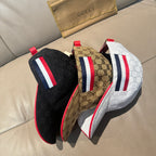 Three Gucci baseball caps: black, brown, and white with red, white, and navy stripes