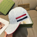 Gucci baseball cap, white jacquard with red and navy striped band, angled view